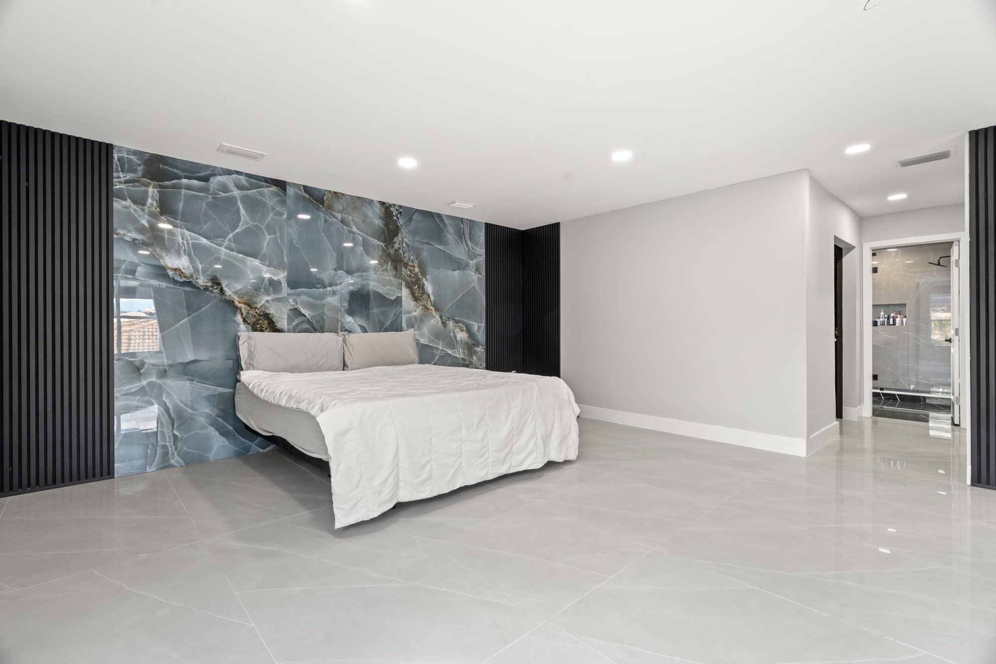 Master bedroom with blue onyx accent wall